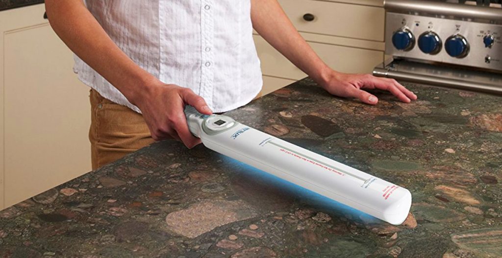 Disinfecting a countertop with a UV light sanitizer