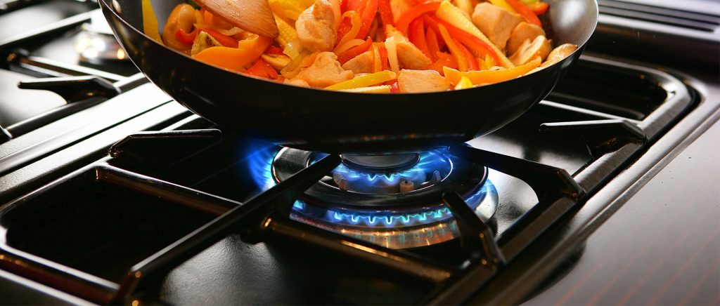 Cooking dinner on a gas stove range