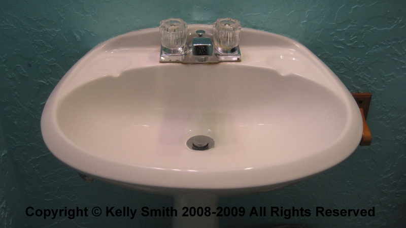 A pedestal sink with typical faucet