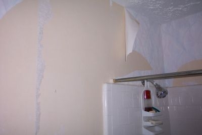 Stripping wallpaper from a bathroom wall